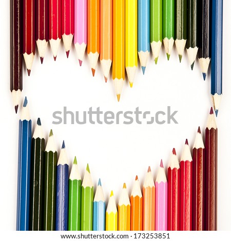 Colored pencils laid out in the shape of heart