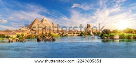 Similar – Picturesque view of water surface near amazing rock hills at sunset and blue sky