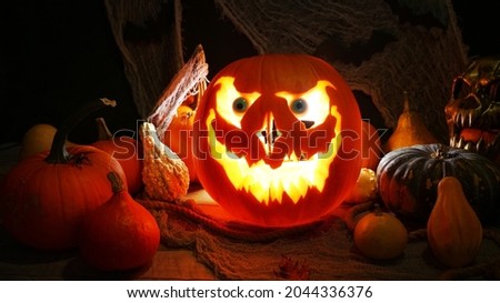 Halloween pumpkin Jack o lantern highlighted. Halloween pumpkins on spooky background, misty fog. October holidays concept. Perfect carved pumpkin and fall spooky decoration.