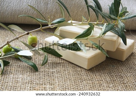 Soap bars with olive oil and olive tree twigs on a sackcloth
