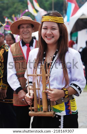 Sipitang, Sabah Malaysia.August 30, 2014 : Lady from the Lundayeh ethnic of Sabah in traditional costume holding musical instruments called \