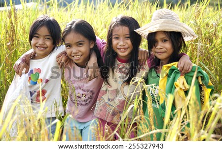 Tambunan, Sabah, Malaysia, December 8, 2013 : All smiles Kadazandusun girls standing in the middle of ripening paddy on December 8, 2013. Kadazandusun is the largest ethnic group in Sabah, Malaysia.