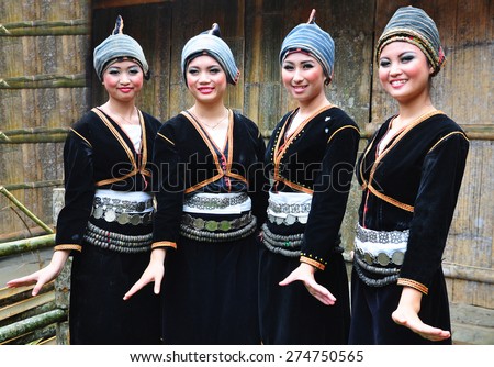 Tambunan, Sabah Malaysia. May 1, 2015 : Ladies from Dusun Tambunan ethnic in Dusun Liwan traditional costume poses for the camera during the Harvest Festival celeberation in Tambunan, Sabah.