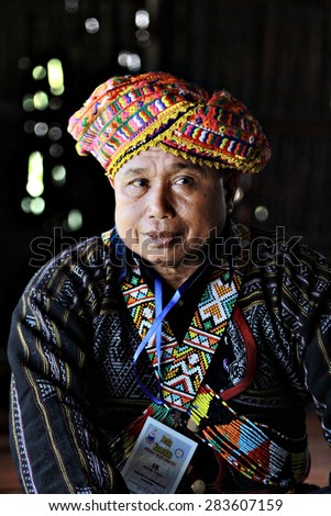 Kota Kinabalu, Malaysia - May 30, 2015: A Rungus man in traditional costume pose for guests during the State Harvest Festival Celeberation in Kota Kinabalu, Sabah.Image with shadow in natural light.
