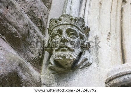 stone kings head sculpture on a building