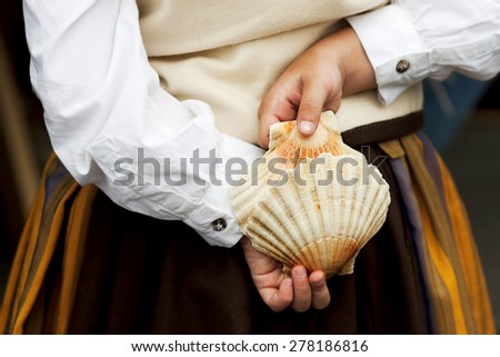 natural instrument scallop shells see pectinidae  and unfocused galician spanish traditional folk costume