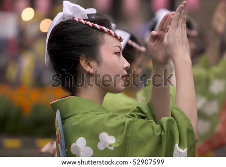 KAGOSHIMA CITY, JAPAN - NOVEMBER 3: A young woman in green yukata kimono dances during the Ohara Matsuri dance festival, November 3, 2005 in Kagoshima City, Japan.