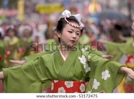 KAGOSHIMA CITY, JAPAN - NOVEMBER 3: A young woman in green yukata kimono dances during the Ohara Matsuri dance festival, November 3, 2005 in Kagoshima City, Japan.