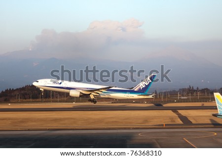 KAGOSHIMA, JAPAN - FEBRUARY 18: Recently active Shinmoedake volcano erupts as  ANA jet takes off from Kagoshima Airport,  February 18, 2011 in Kagoshima, Japan. Volcanic ash has disrupted air traffic.