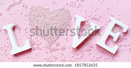 Banner.The word love in white letters on a trendy pink background. Happy Valentine's Day, Mother's Day, March 8, World Women's Day holiday card concept. Flat lay. 
