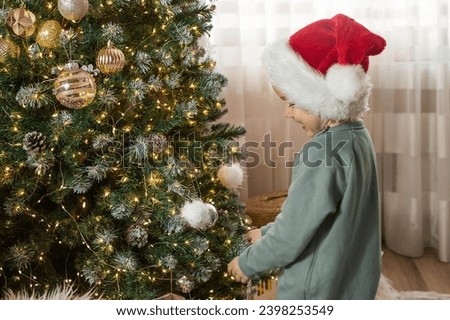 Similar – Image, Stock Photo Child decorating the tree seen from behind