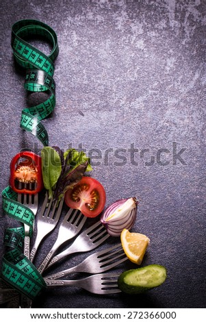 Fresh mixed vegetables on fork with measuring tape