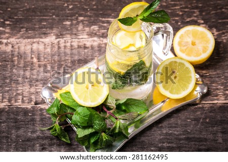 refreshing citrus lemonade,summer drink. Lemonade with fresh lemon on wooden table