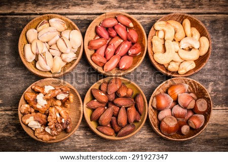 Assortment of nuts on wooden old table,healthy vegan food.