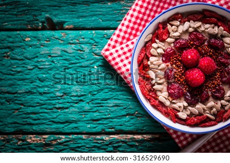 Breakfast banana smoothie bowl topped with goji berries,raspberry, sunflower and chia seeds. healthy food