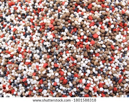 Compound fertilizer or mixed fertilizer. Bulk fertilizer is red, brown, and white. Background and surface of chemical compounds, element N (nitrogen), P (phosphorus) or K (potassium). Selective focus Stock fotó © 