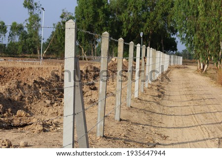 Similar – Image, Stock Photo barbed wire and concrete military fence on the beach near the sea in Crimea