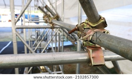 Metal scaffolding pipe clamp. Steel scaffolding and mounting parts for strength in construction sites or concert stage supports. Close-up and select focus Сток-фото © 