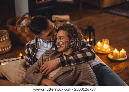 Similar – Image, Stock Photo Romantic couple cuddling in blanket on terrace