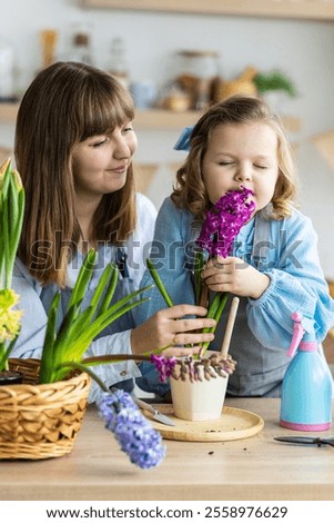 Similar – Foto Bild Kleine Tochter macht mit der Mutter zu Hause einen handgemachten Pompon