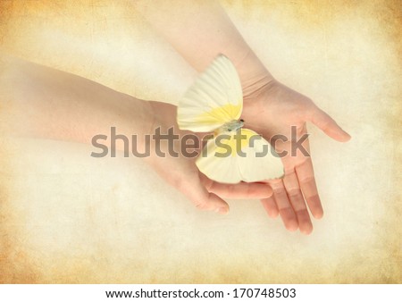 Butterfly releasing from woman's hands.
