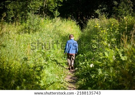 Similar – Image, Stock Photo Little boy walking across meadow, father in the background