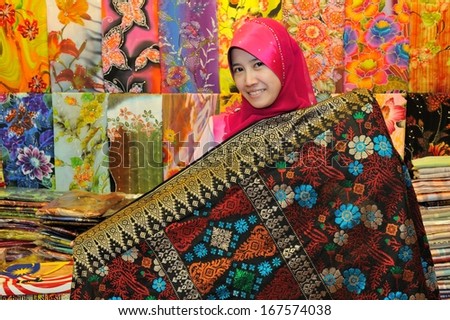 TERENGGANU-DEC 11 : Unidentified traditional Malaysia Batik seller at Pasar Payang on December 11, 2012 in Terengganu Malaysia. Malaysia Batik is famous for its Quality