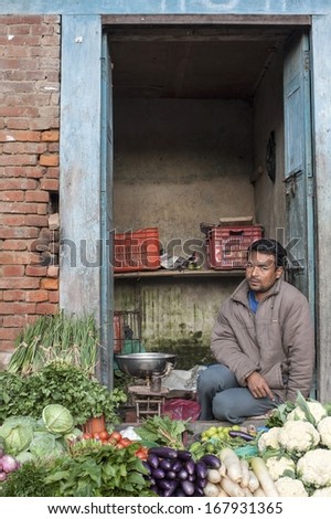 BHAKTAPUR, NEPAL - NOV 7  : Unidentified man sits selling vegetable in Bhaktapur, Nepal on November 7, 2012