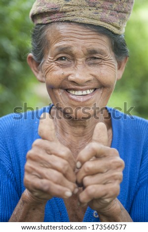 BALI, INDONESIA - MAY 9: Portrait of unidentified old woman to Bali island. Inhabitants of Bali are kind and friendly even in old age on May 9, 2012 in Bali, Indonesia