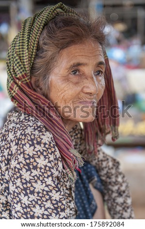 SKUON, CAMBODIA - DECEMBER 22 : Unidentified portrait of seller at Skuon market wearing a (traditional checkered scarf worn by Khmers) in Skuon, Cambodia on December 22, 2011
