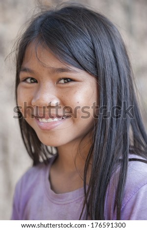 SIEM REAP, CAMBODIA - DEC 30: An unidentified Khmer girl poses for a photo on December 30, 2012 in Siem Reap, Cambodia.