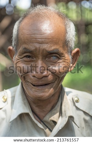 KAMPONG PHLUK,CAMBODIA-APRIL 17:Portrait of an unidentified asian man on Tonle Sap Lake in Kampong Phluk,Cambodia on April 17, 2014.It is the largest lake in Southeast Asia (up to 16,000 square km).