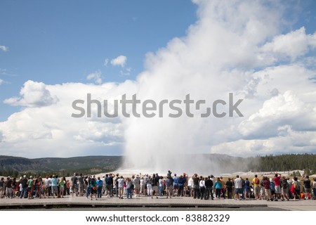 Yellowstone National Park  Tourists watching Old Faithful in Yellowstone National Park while it erupts.