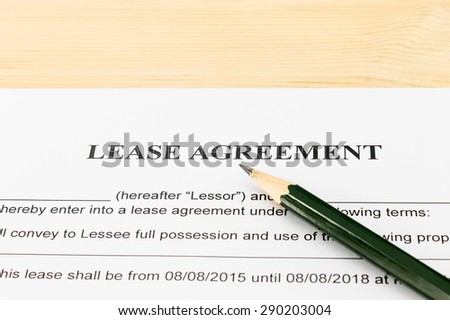 Lease Agreement Contract Document and Pencil Horizontal View on Wood Table in Vintage Style. Legal document for business event