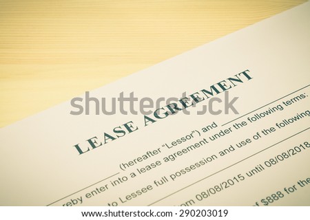 Lease Agreement Contract Document on Wood Table in Vintage Style. Legal document for business event