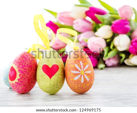 Easter eggs and tulips bunch beside