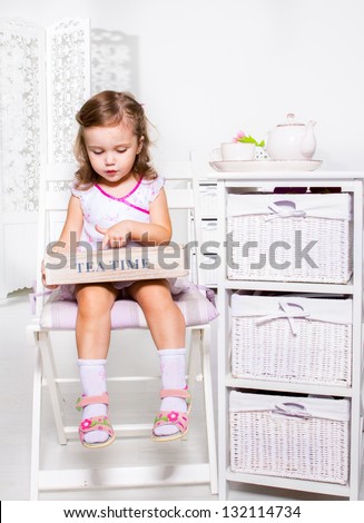 Little girl holding wooden box with tea bags