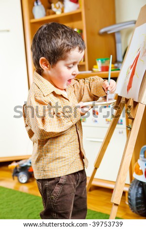 Cute preschool boy painting