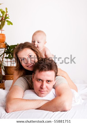 Lovely happy family in the bedroom