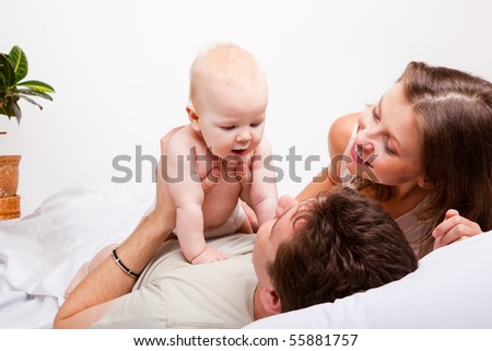 Lovely happy family in the bedroom