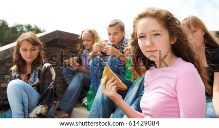Teens eating take away food