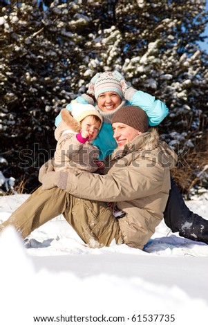 Happy young family playing in the snow