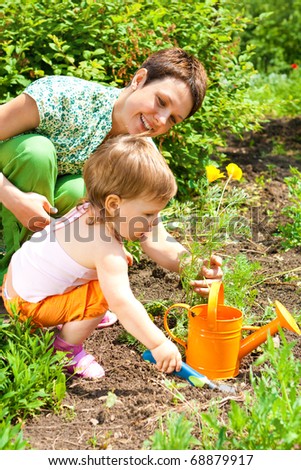 Mother and toddler daughter\'s spring gardening