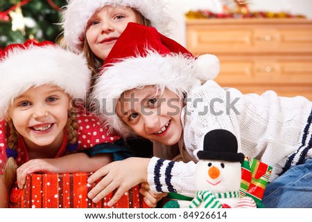 Portrait of cheerful kids in Christmas hats