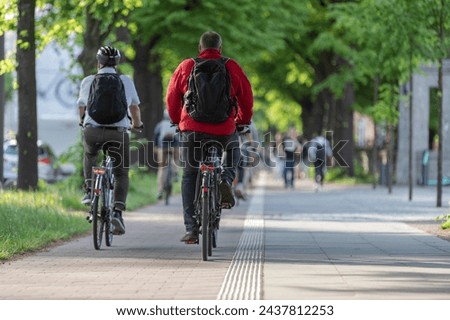 Similar – Foto Bild Radweg mit roter Fahrbahnmarkierung bei winterlichen Straßenverhältnissen.