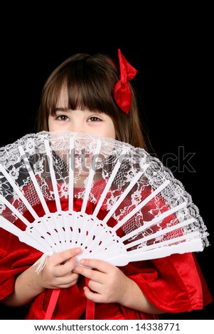 little girl in red, peeking from behind lace fan