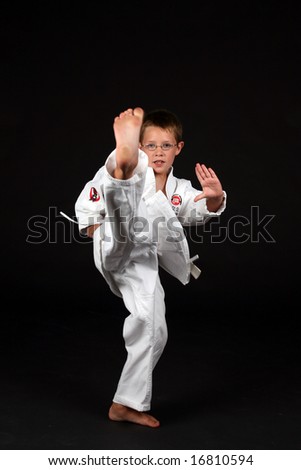 boy demonstrating traditional karate front snap kick
