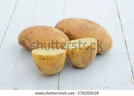 Two and one sliced potato on the table
