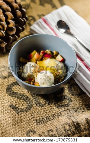 Bowl of yogurt; cut fruits and honey by napkin on sack
