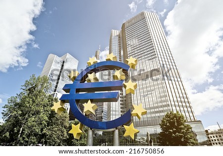 FRANKFURT AM MAIN, GERMANY -  MAY 14, 2014: Euro sign in front of the European Central Bank (Europaeische Zentral Bank) headquarter building